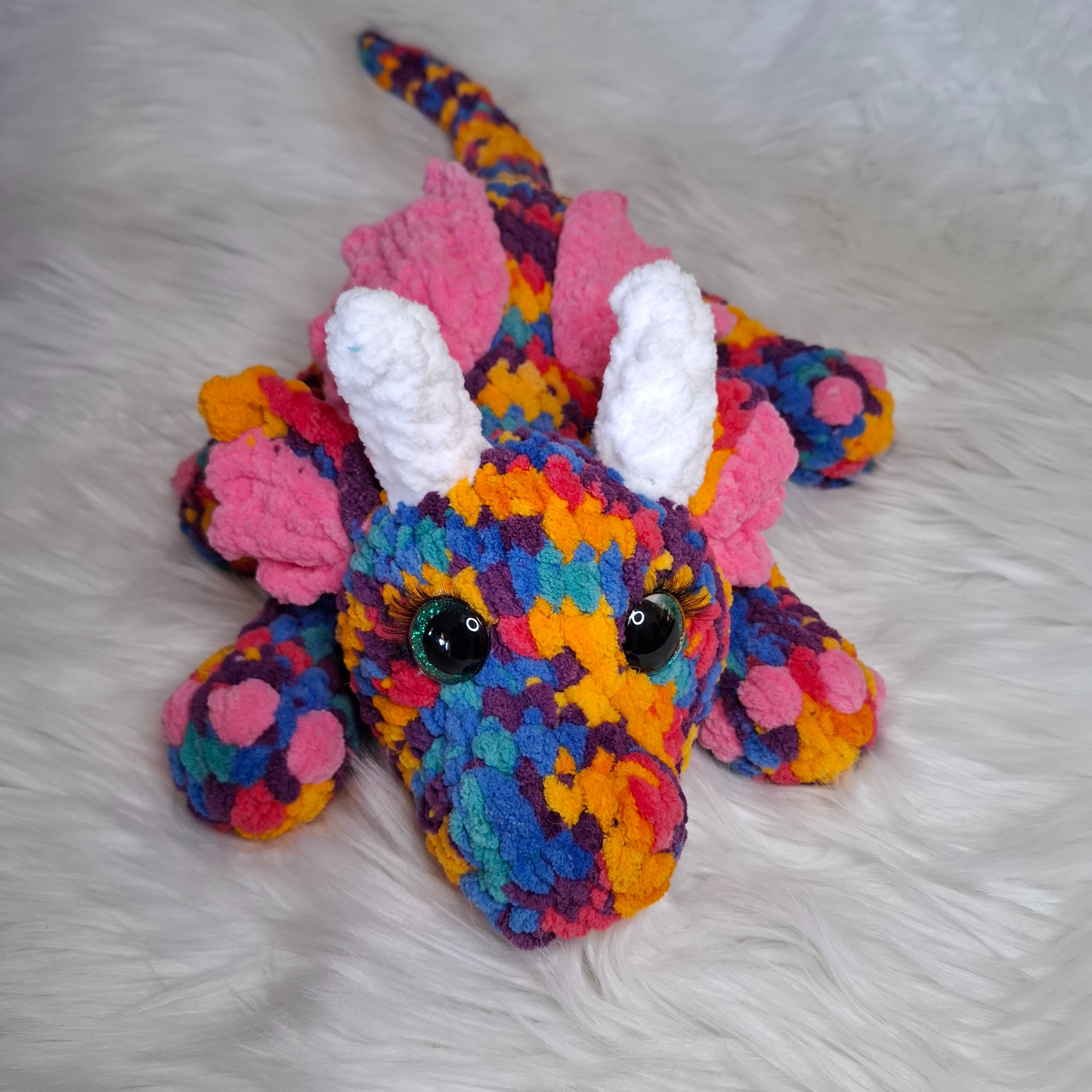 Handmade crochet dragon: bright rainbow colours